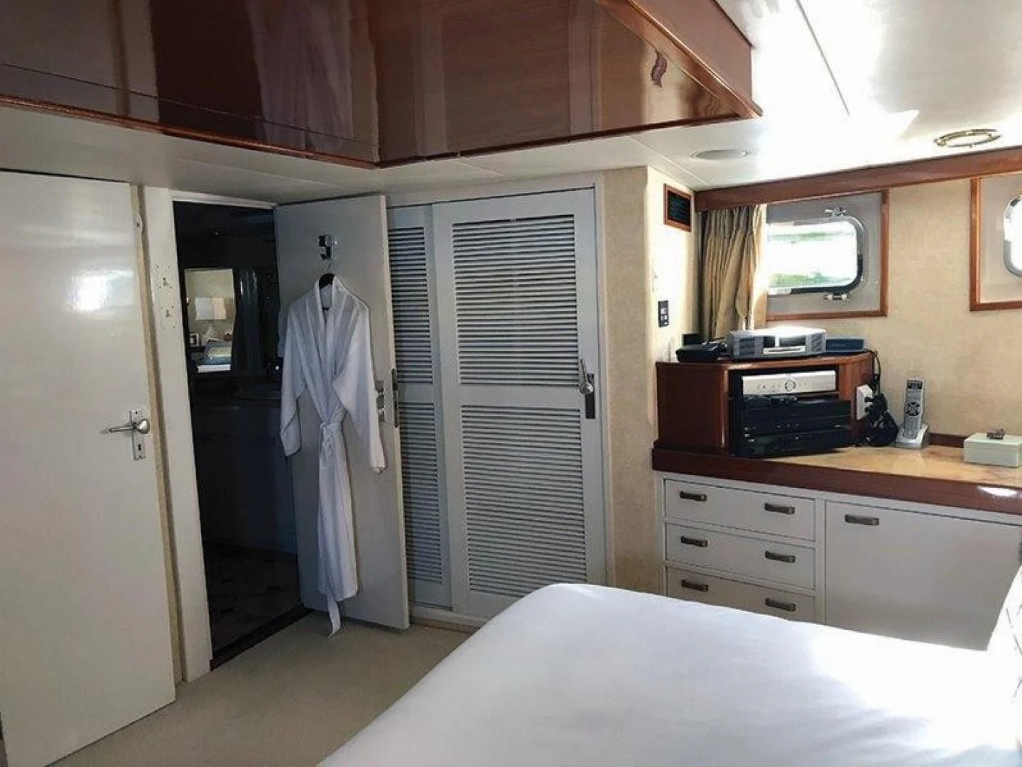 a room with a bed and a closet aboard SEA CZAR Yacht for Sale
