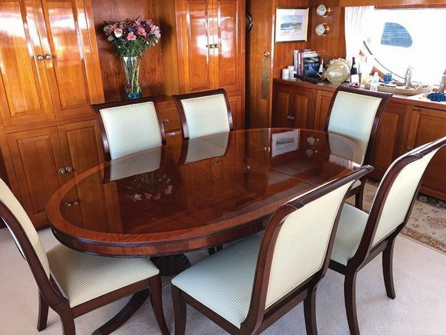 a table with chairs around it aboard SEA CZAR Yacht for Sale