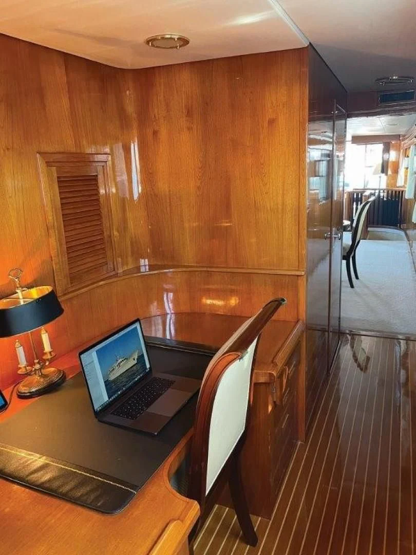a laptop on a table aboard SEA CZAR Yacht for Sale