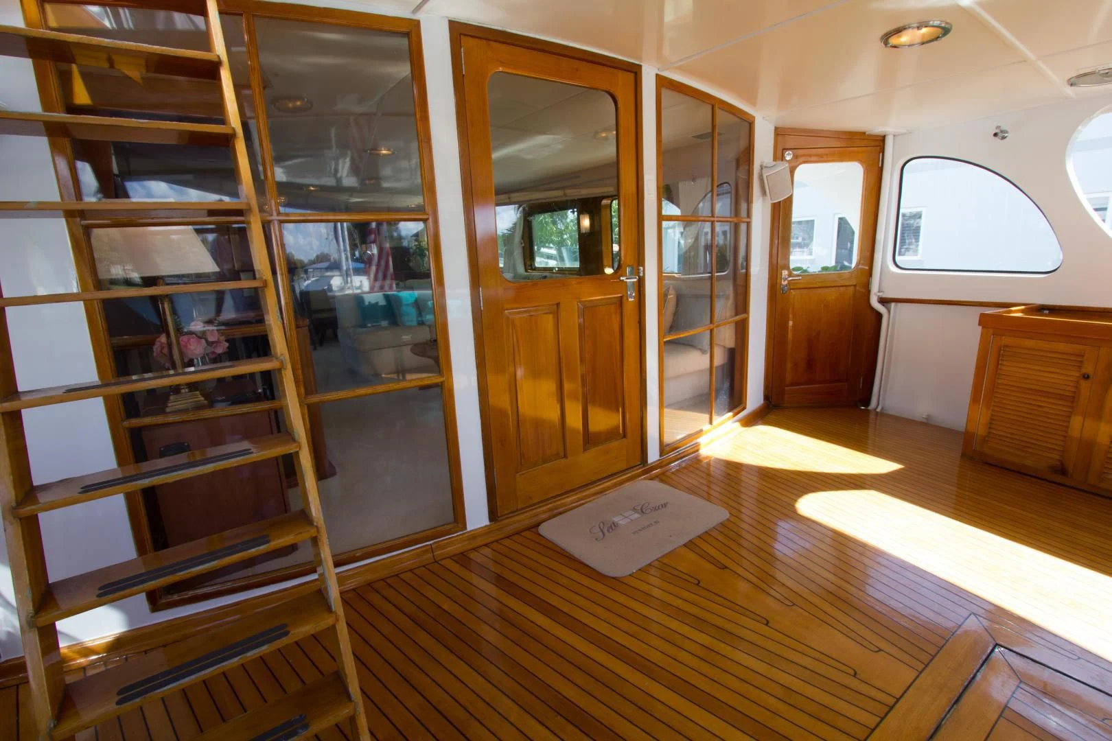 a room with a wood floor and a glass door aboard SEA CZAR Yacht for Sale