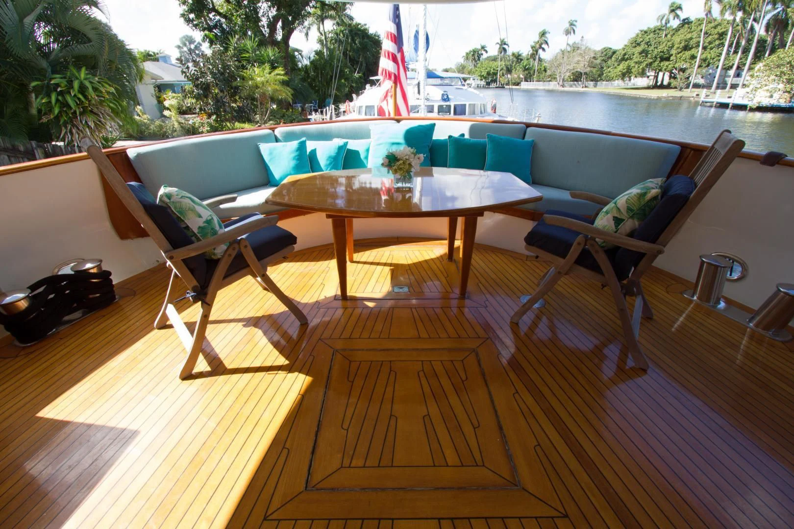 a deck with a table and chairs aboard SEA CZAR Yacht for Sale
