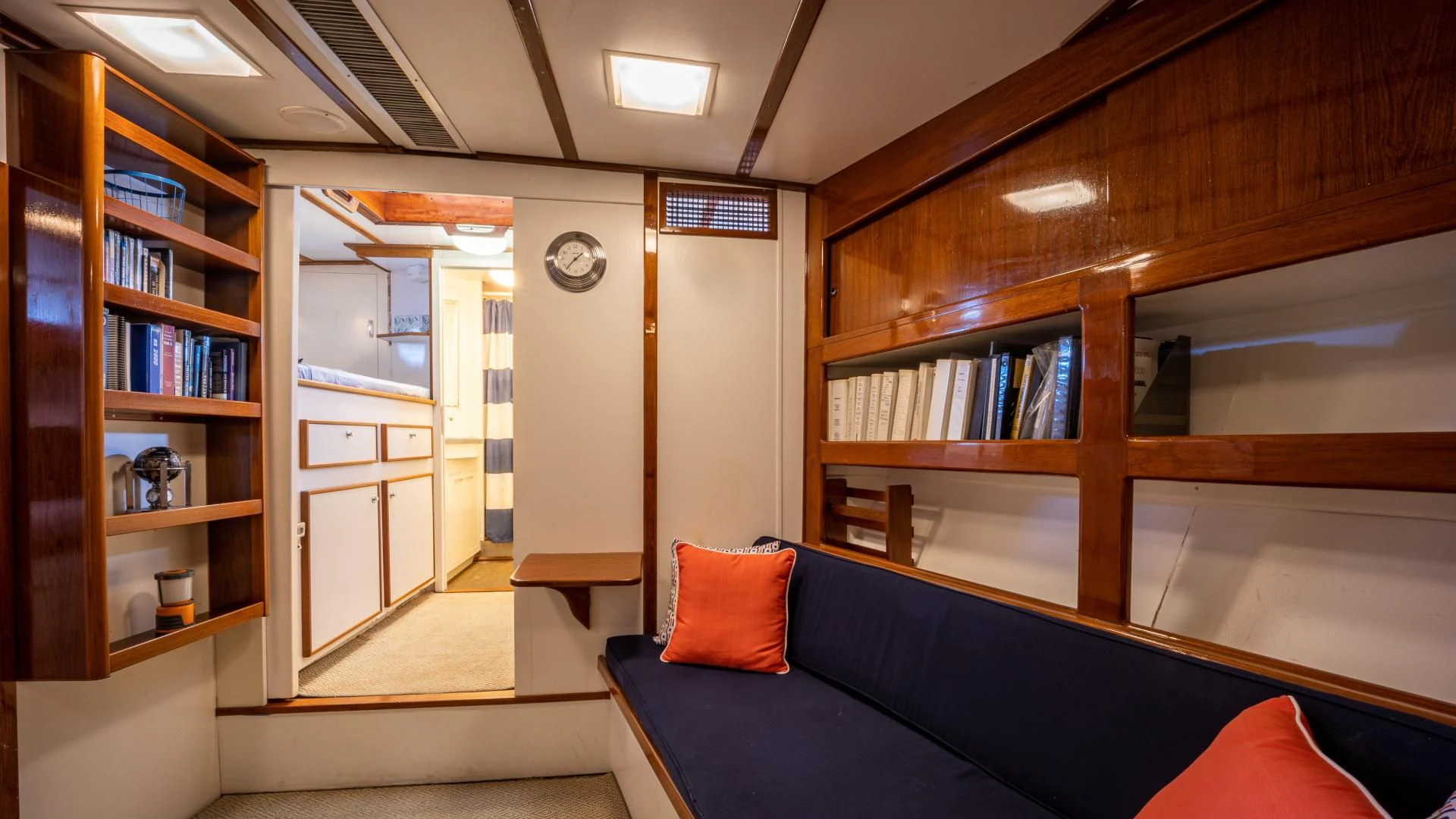 a room with a couch and bookshelves aboard SEA CZAR Yacht for Sale