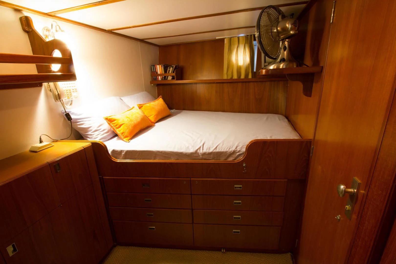 a bed with a wooden headboard aboard SEA CZAR Yacht for Sale