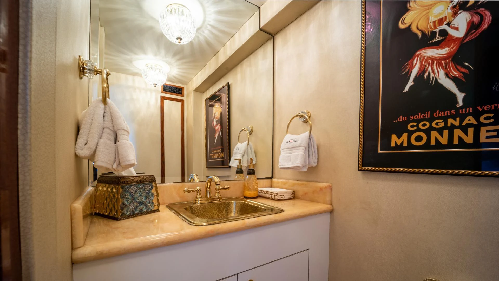 a bathroom with a sink and a painting on the wall aboard SEA CZAR Yacht for Sale
