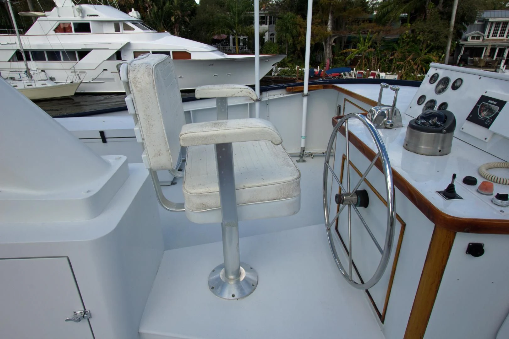 a white boat with a metal steering wheel and a white surface aboard SEA CZAR Yacht for Sale