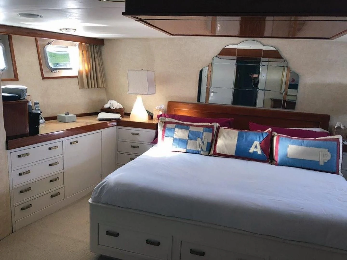 a bedroom with a bed and a dresser aboard SEA CZAR Yacht for Sale