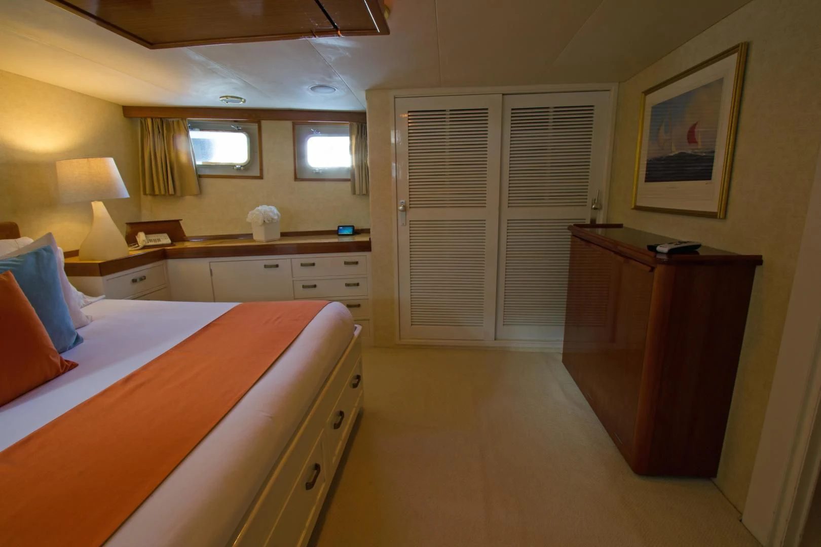 a bedroom with a bed and a desk aboard SEA CZAR Yacht for Sale