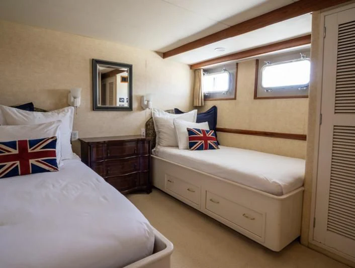 a bedroom with two beds aboard SEA CZAR Yacht for Sale