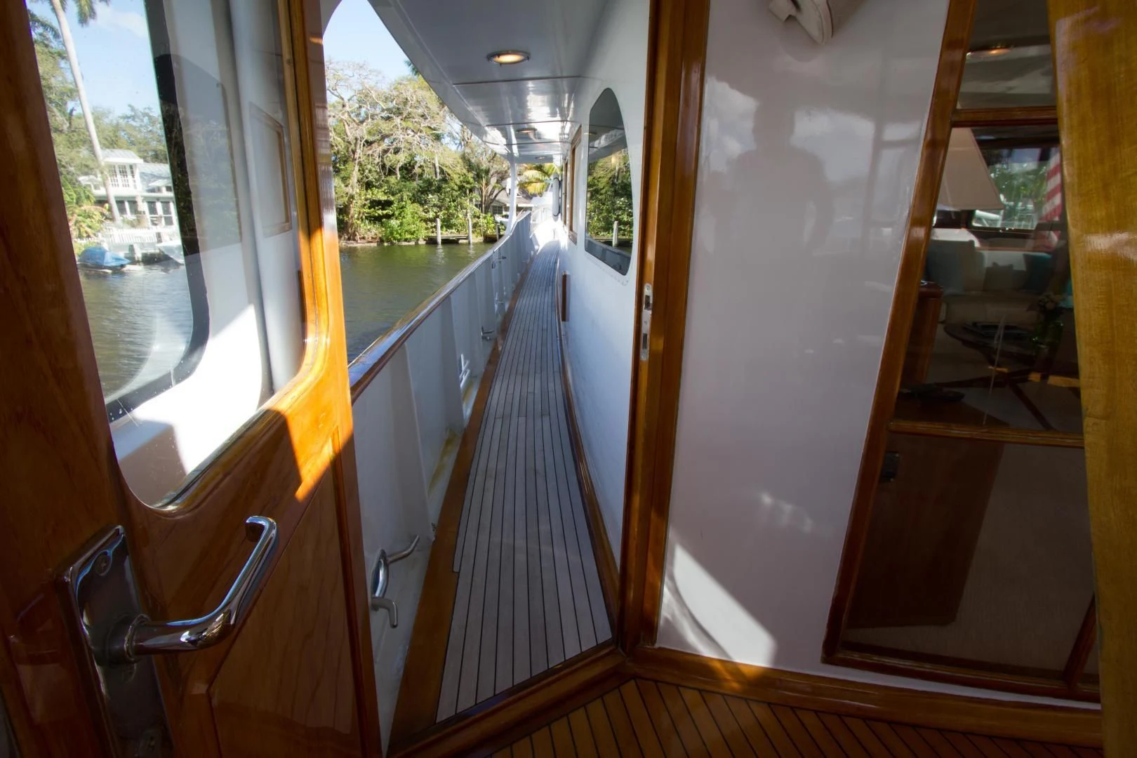 a view of a deck and a pool from the inside of a house aboard SEA CZAR Yacht for Sale