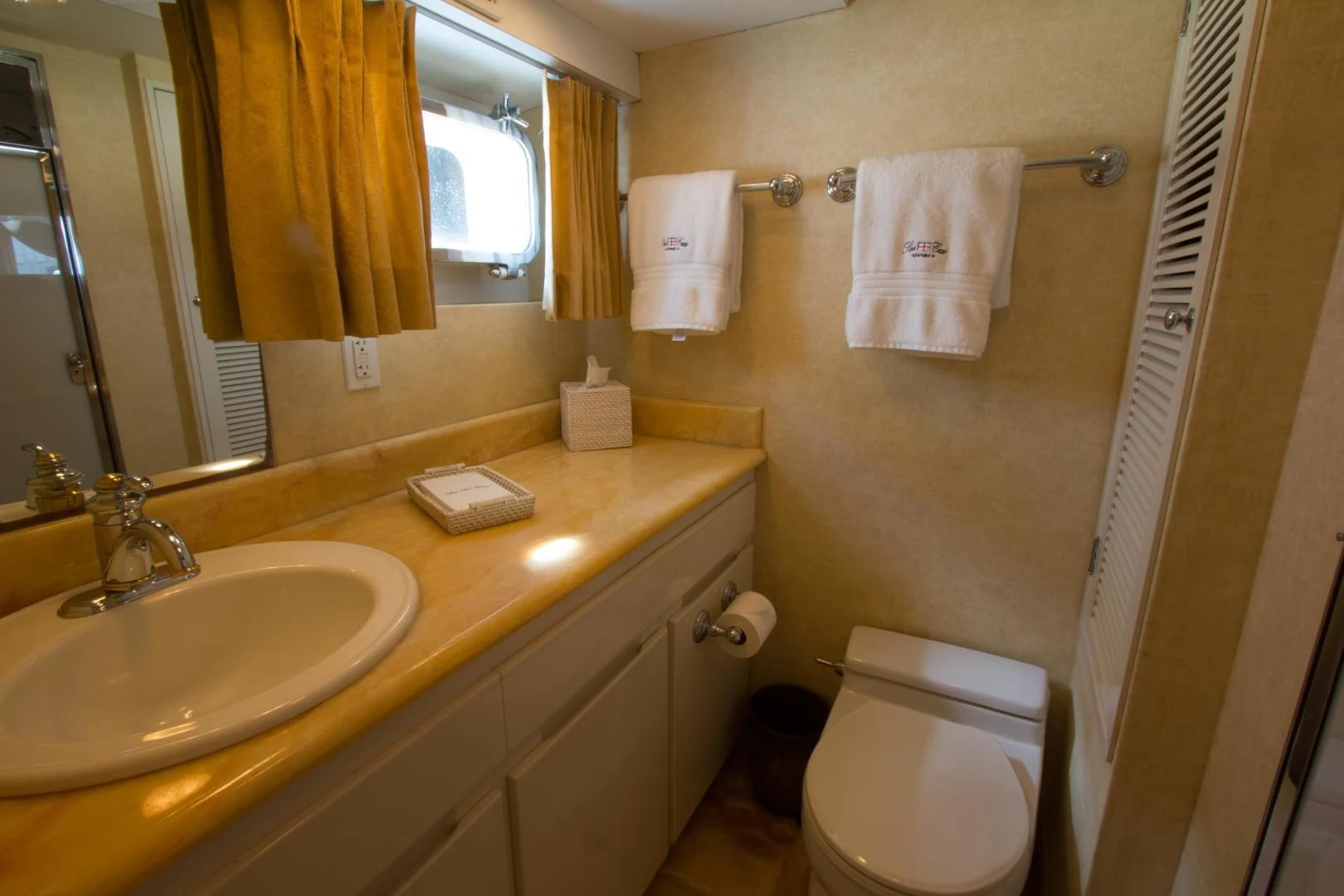 a bathroom with a toilet and a sink aboard SEA CZAR Yacht for Sale