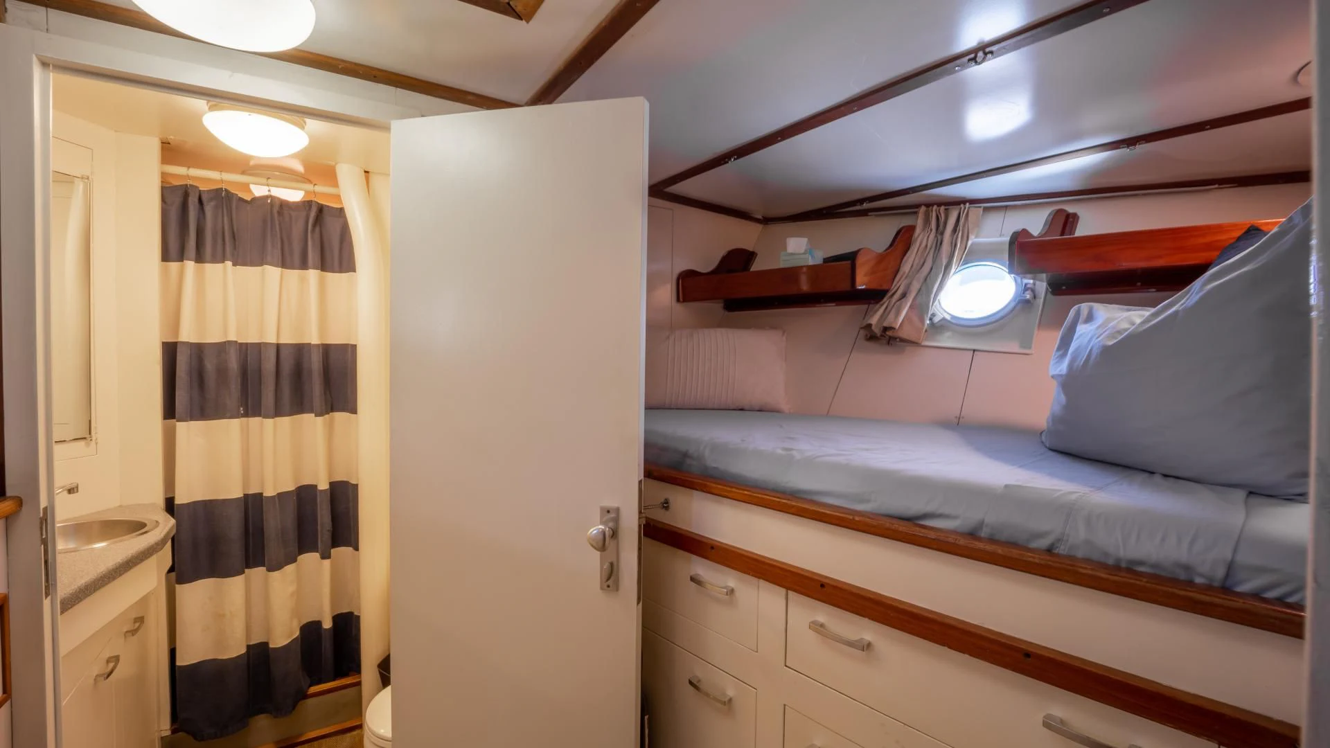 a bedroom with a bed and a closet aboard SEA CZAR Yacht for Sale