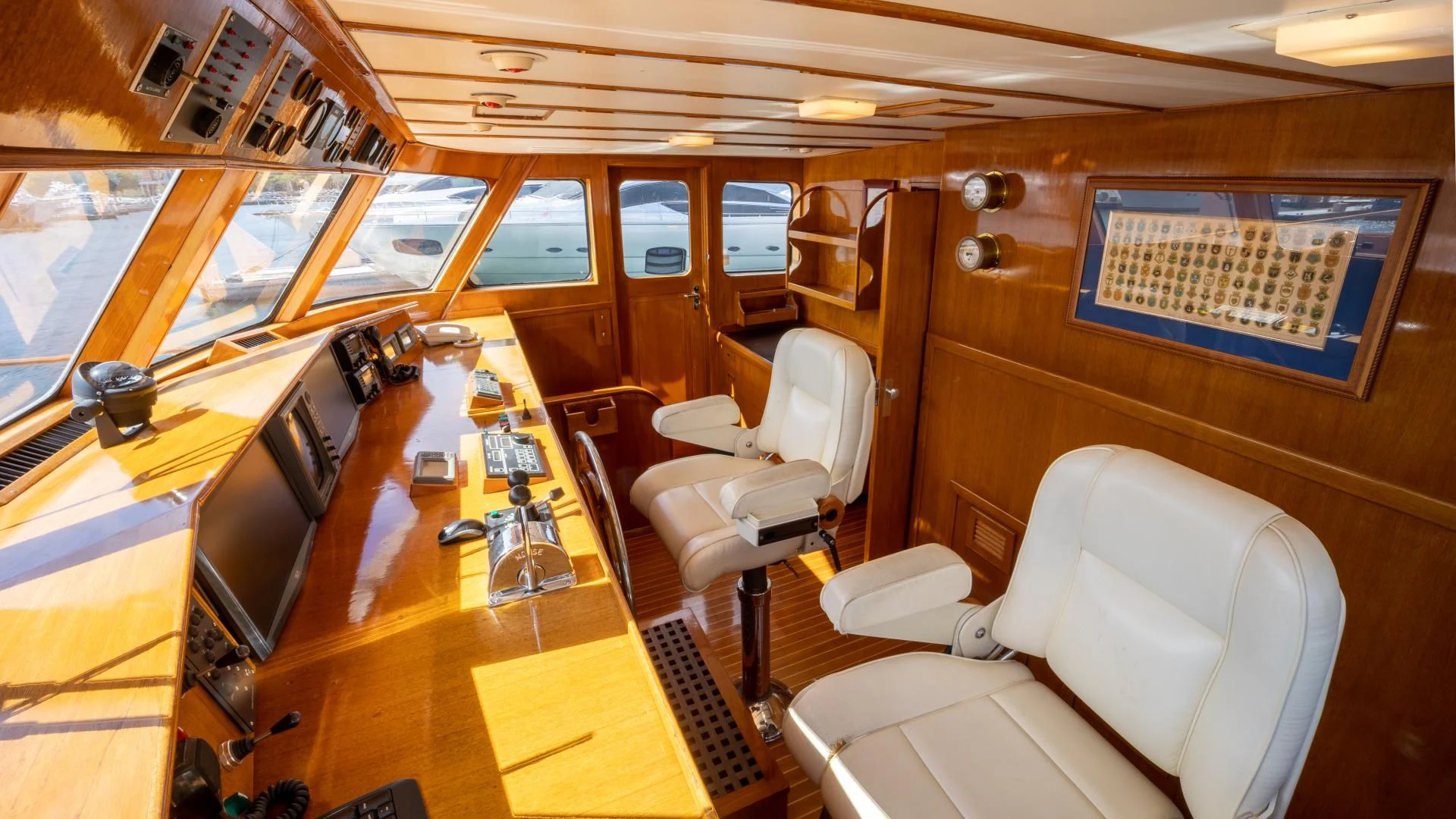 a room with a table chairs and a television aboard SEA CZAR Yacht for Sale