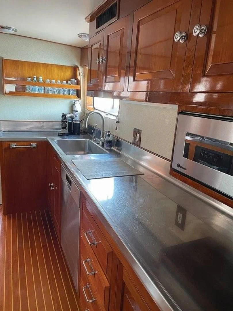 a kitchen with wooden cabinets aboard SEA CZAR Yacht for Sale