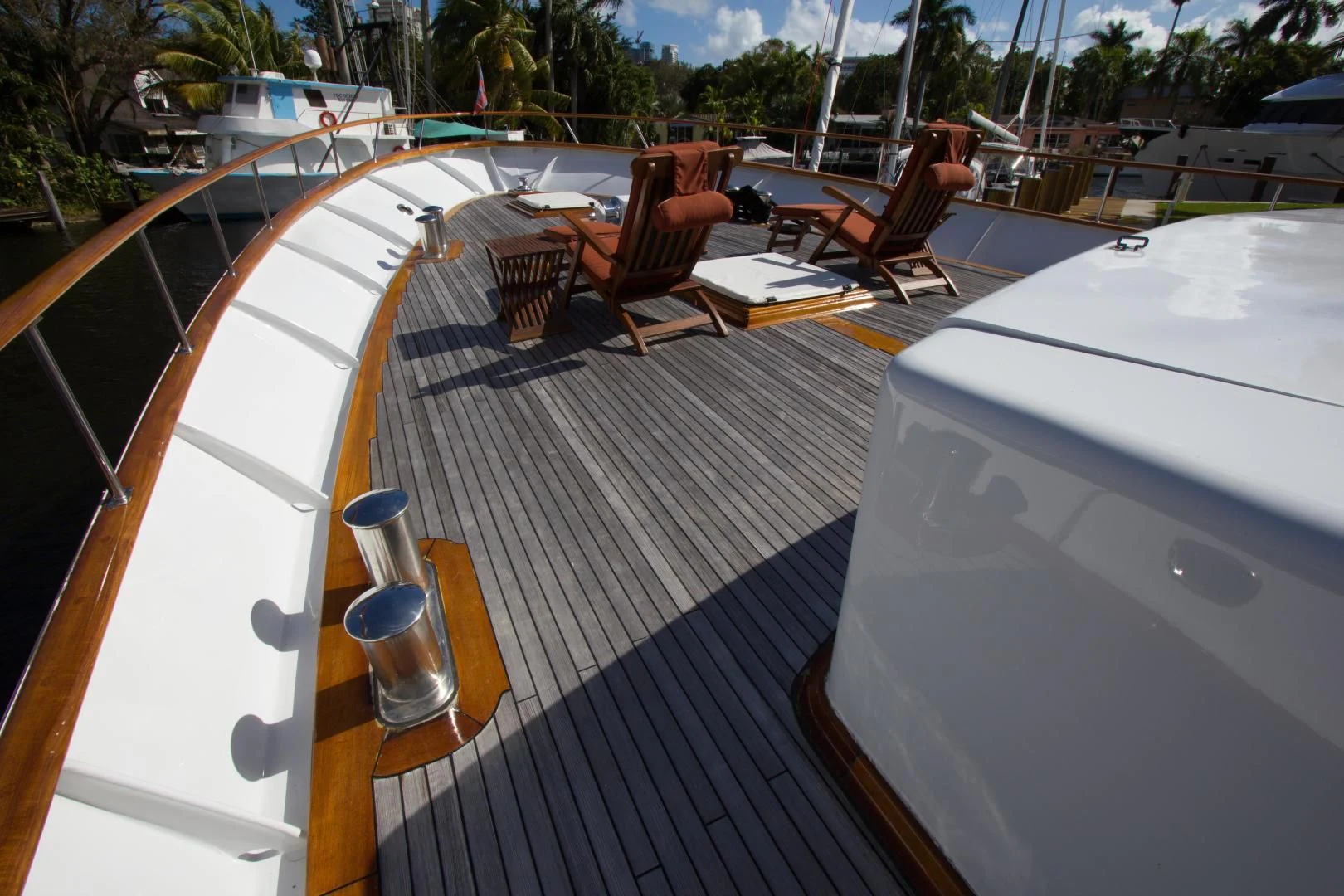 a deck with a table and chairs on it aboard SEA CZAR Yacht for Sale