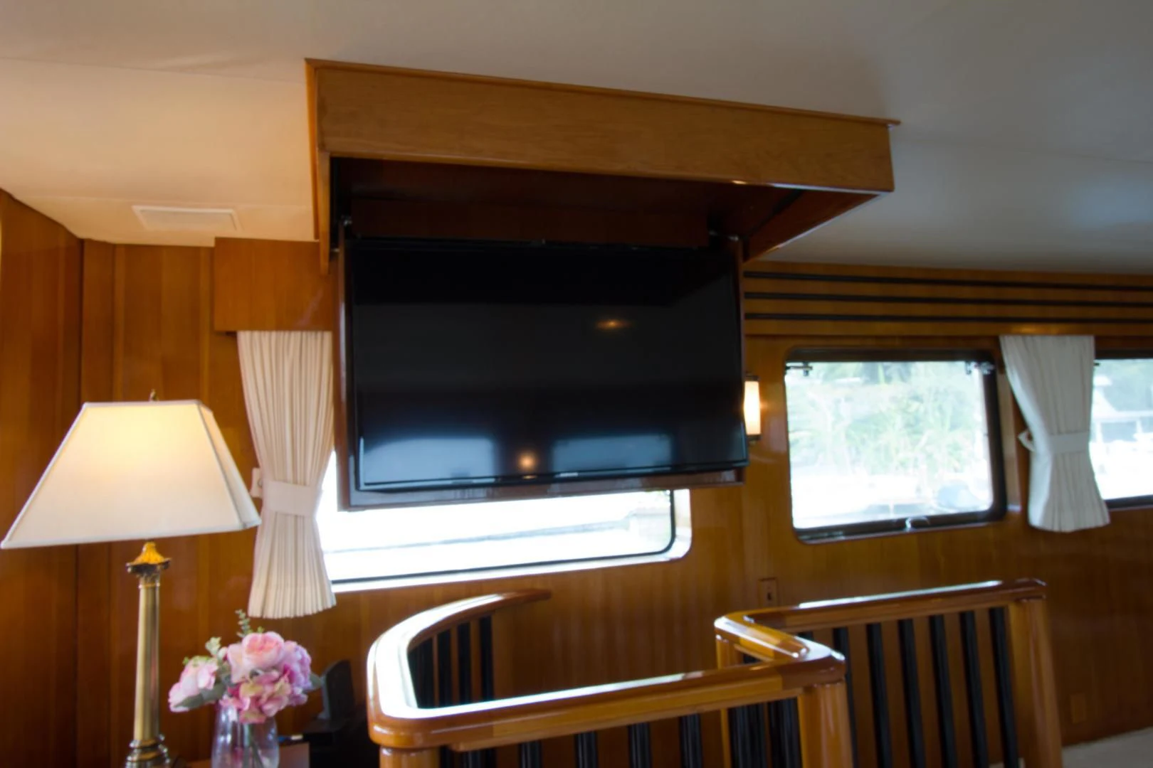 a room with a television and a table and chairs aboard SEA CZAR Yacht for Sale