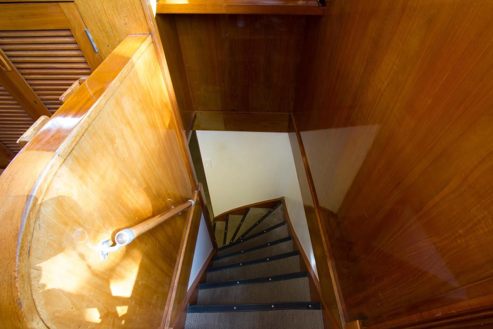 a wooden staircase with a wood railing aboard SEA CZAR Yacht for Sale