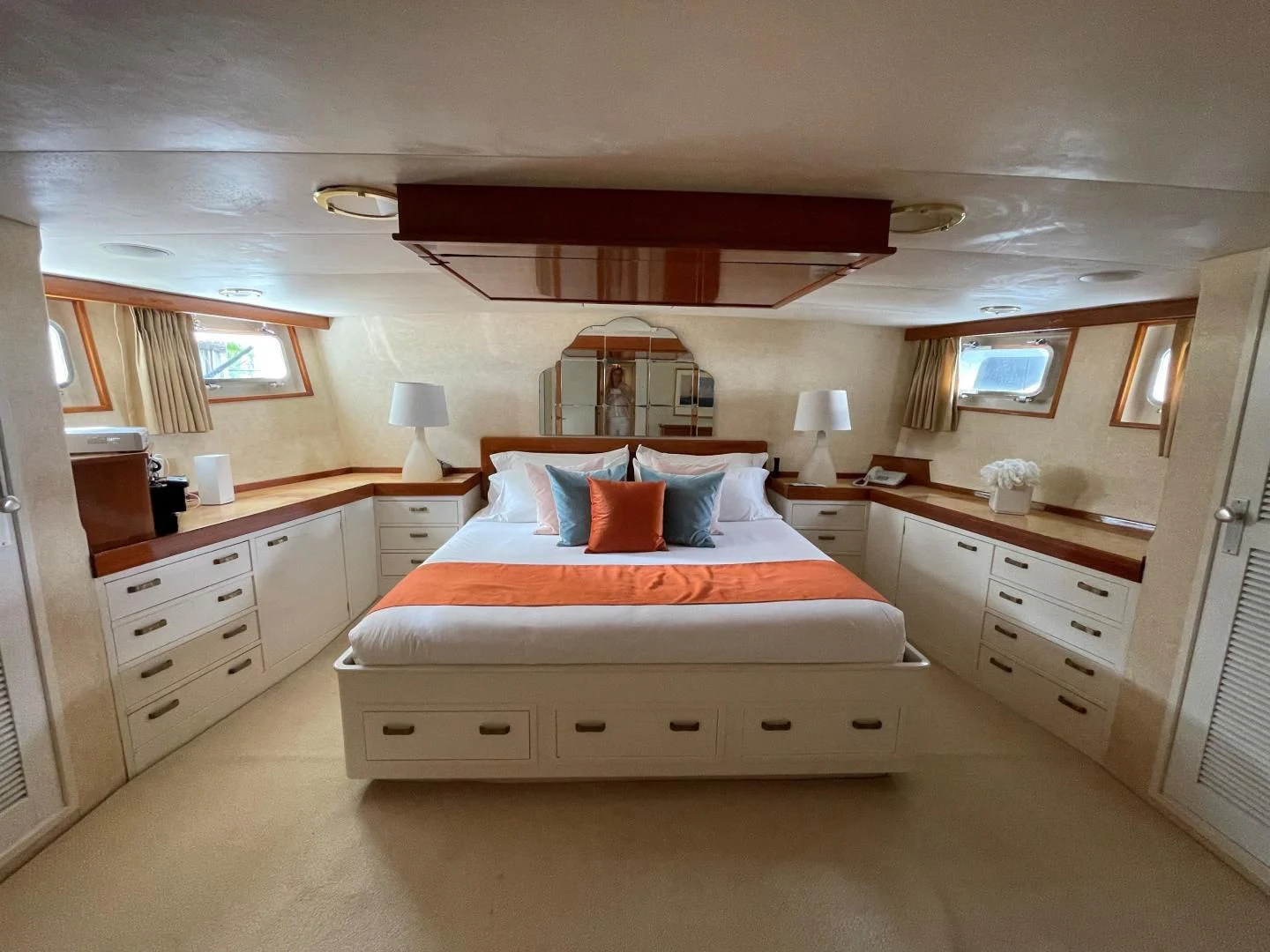 a bedroom with a bed and a dresser aboard SEA CZAR Yacht for Sale