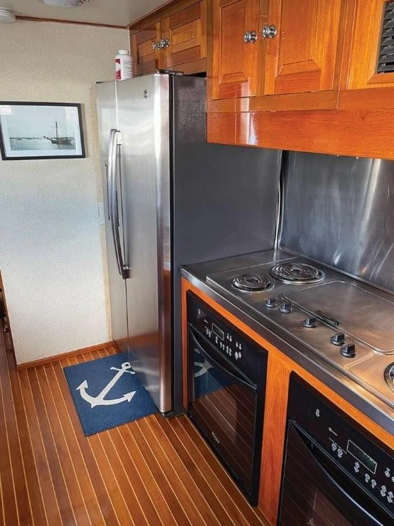a kitchen with a stainless steel stove aboard SEA CZAR Yacht for Sale
