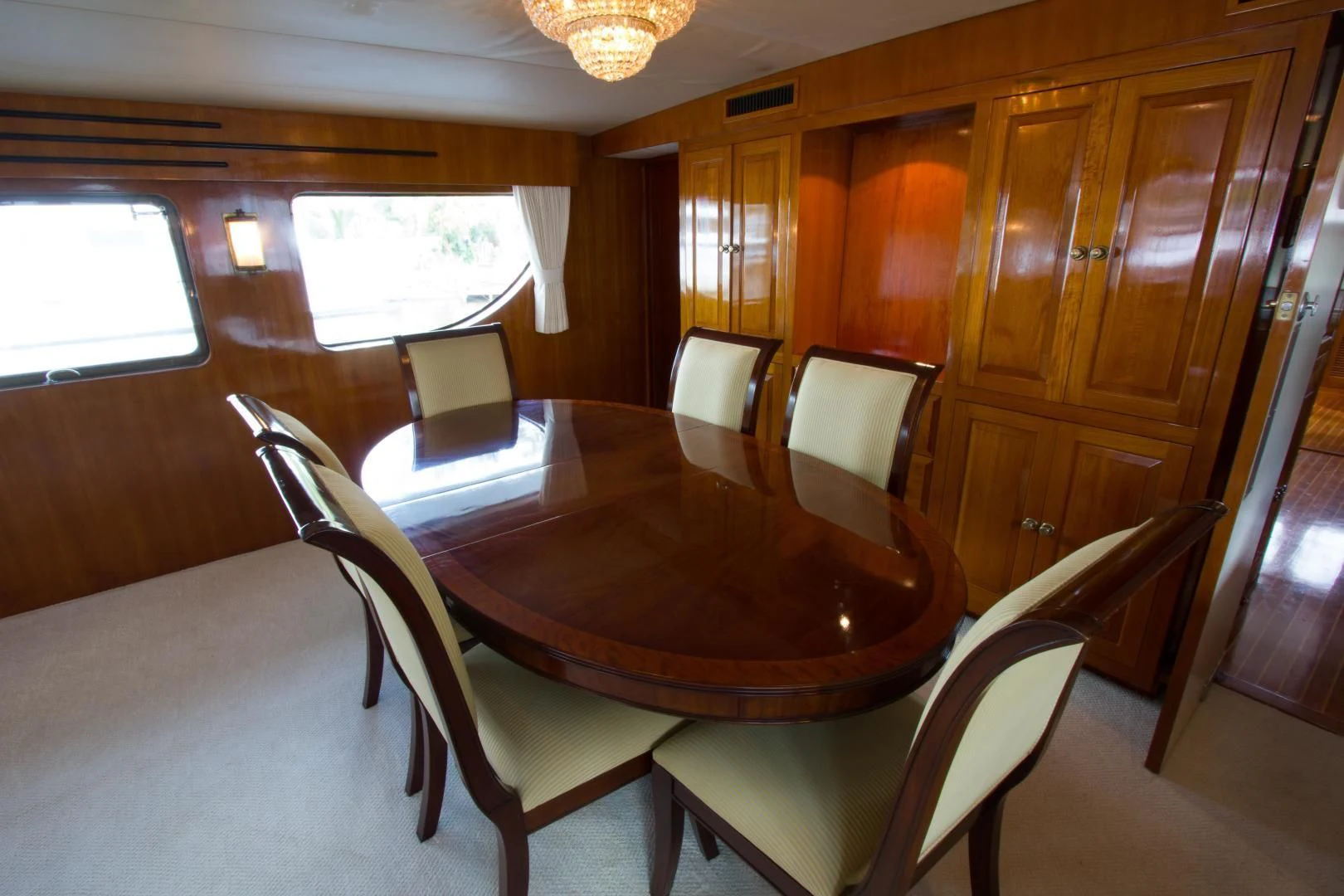 a dining table and chairs in a room aboard SEA CZAR Yacht for Sale