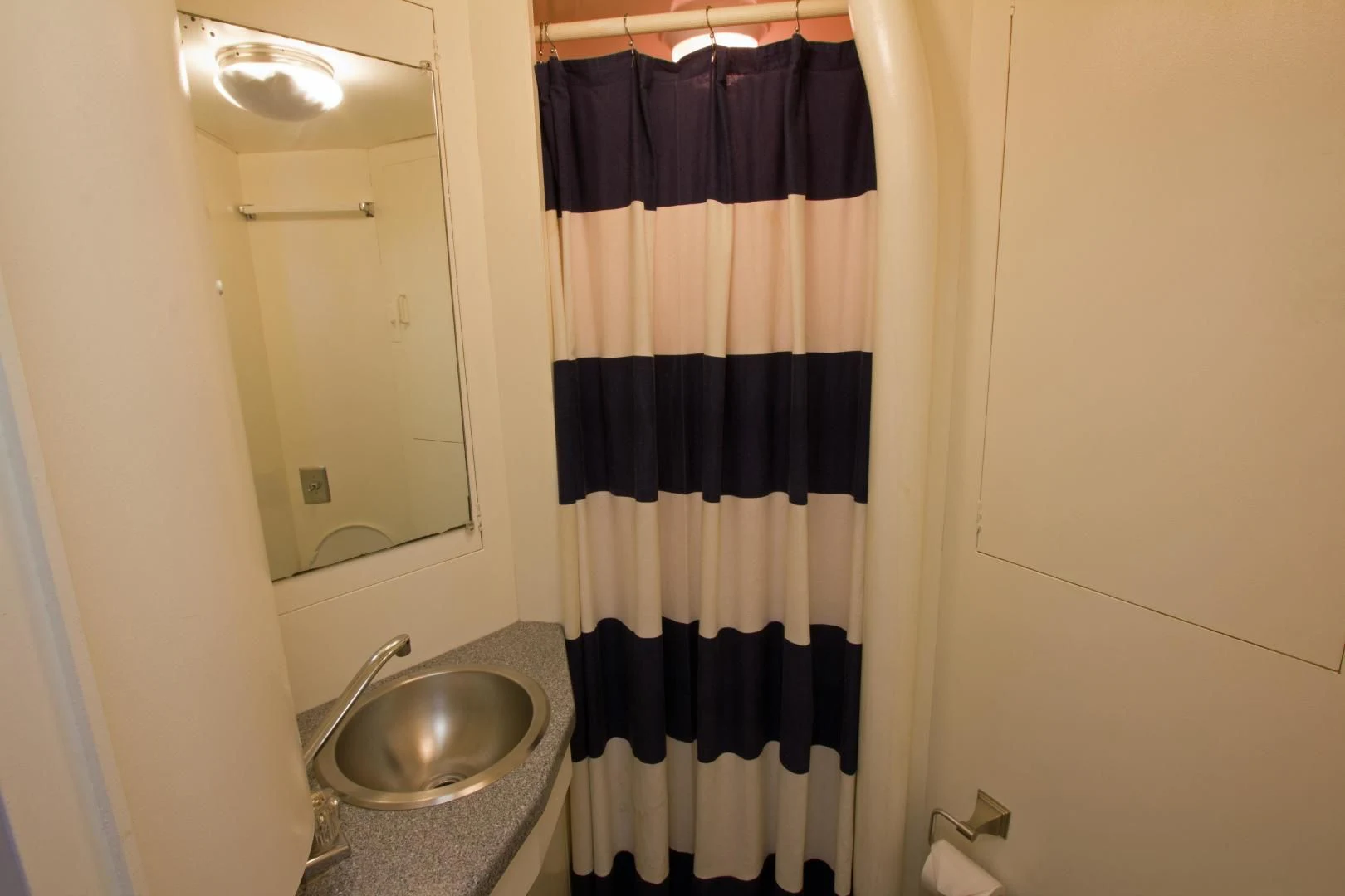 a bathroom with a black and white shower curtain aboard SEA CZAR Yacht for Sale