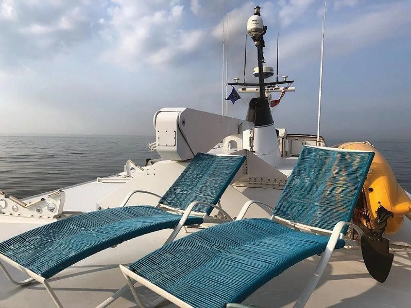 a boat with a blue cover and a blue chair on it aboard SEA CZAR Yacht for Sale