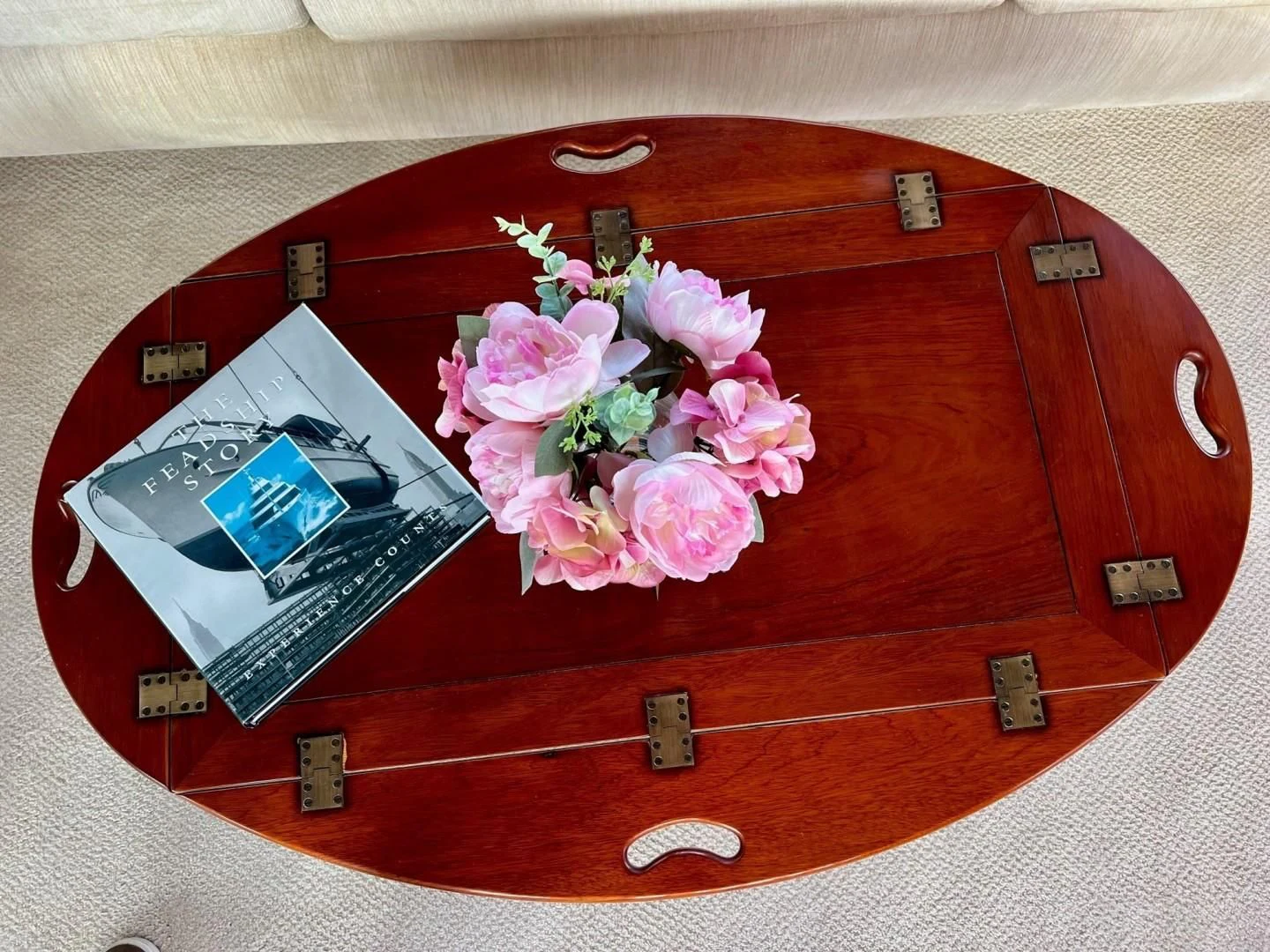 a red purse with flowers and a cell phone on it aboard SEA CZAR Yacht for Sale