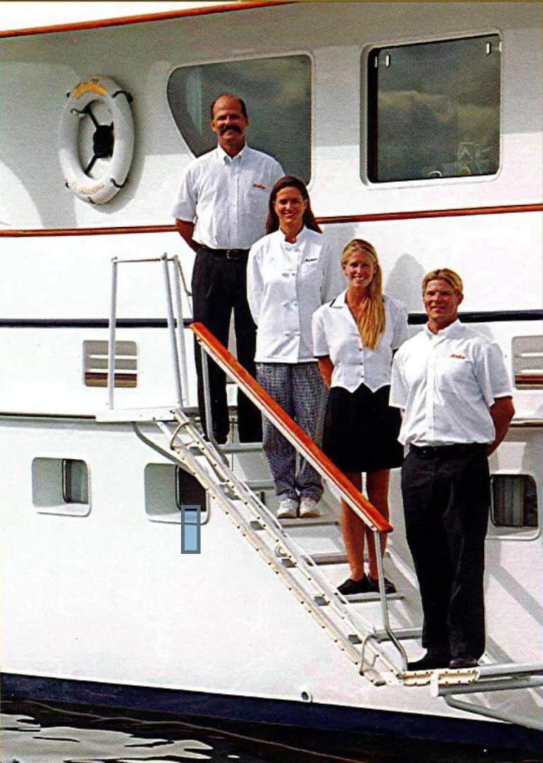 a group of people standing on a staircase aboard SEA CZAR Yacht for Sale