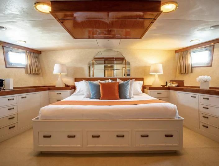 a bed with a white bed spread aboard SEA CZAR Yacht for Sale