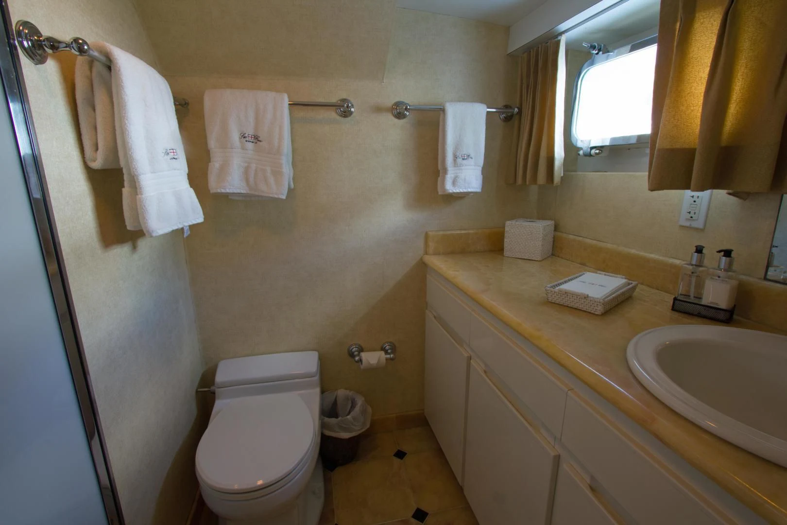 a bathroom with a toilet and sink aboard SEA CZAR Yacht for Sale