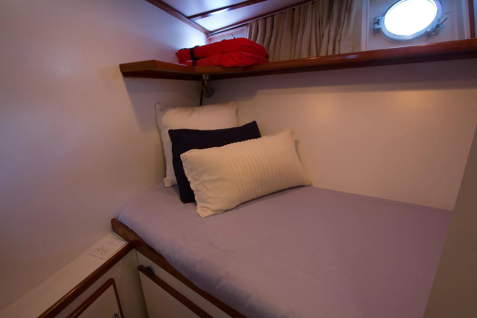a bed with a pink pillow aboard SEA CZAR Yacht for Sale