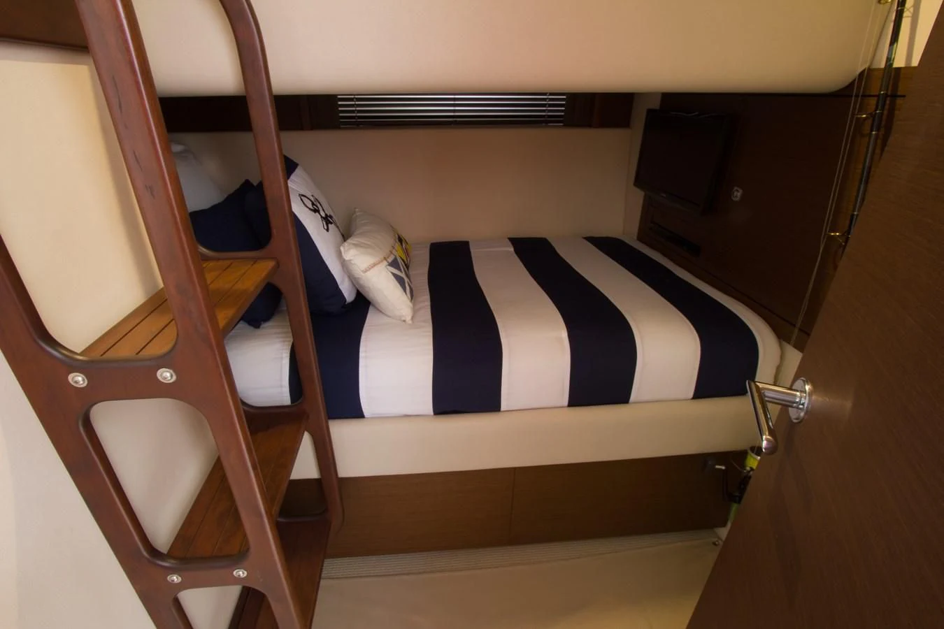 a bunk bed with a striped pillow aboard SEA CZAR Yacht for Sale