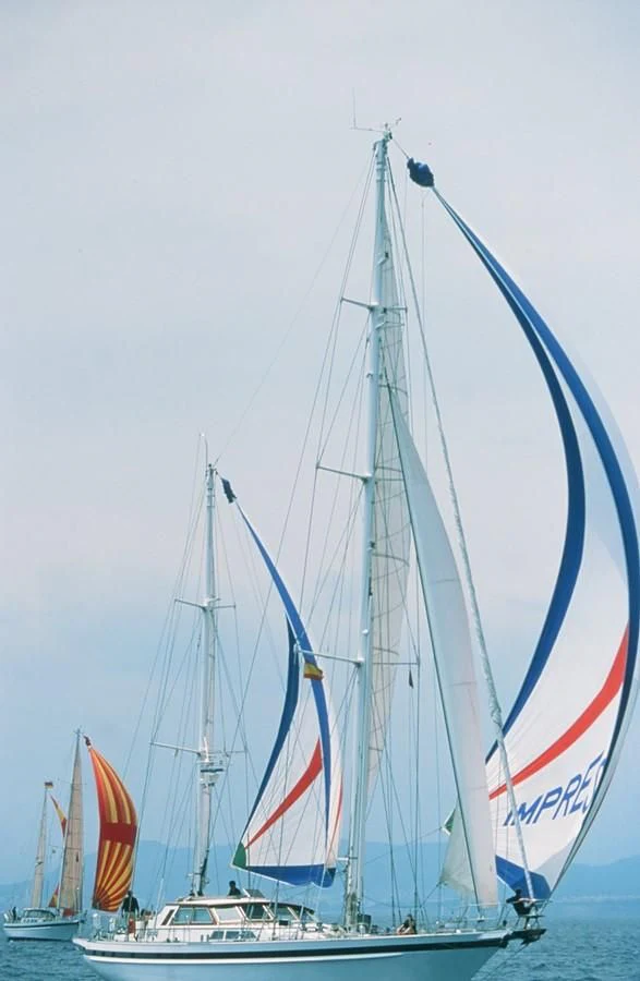 a sailboat with a flag on it aboard IMPRESSION Yacht for Sale