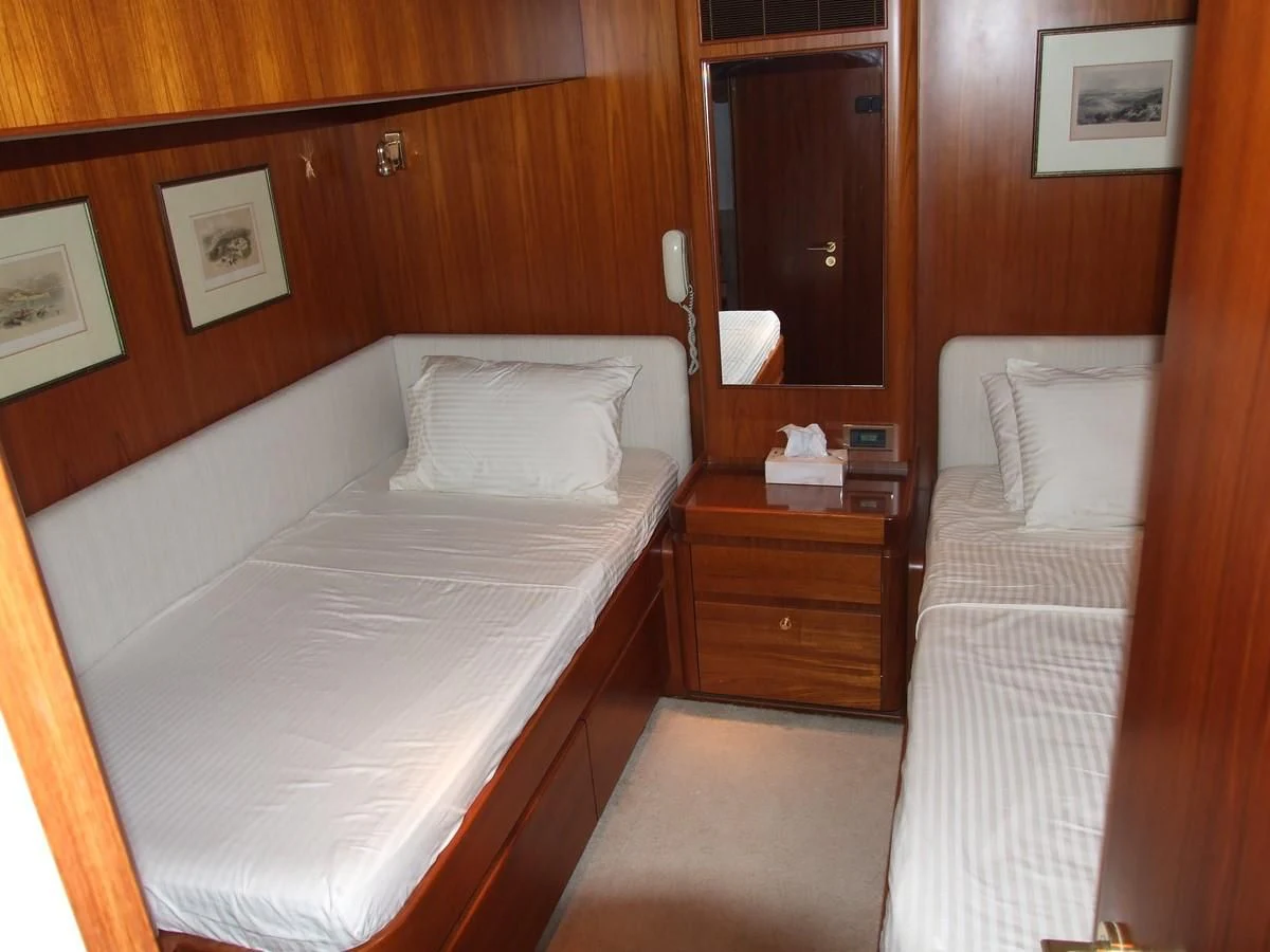 a room with two beds aboard IMPRESSION Yacht for Sale