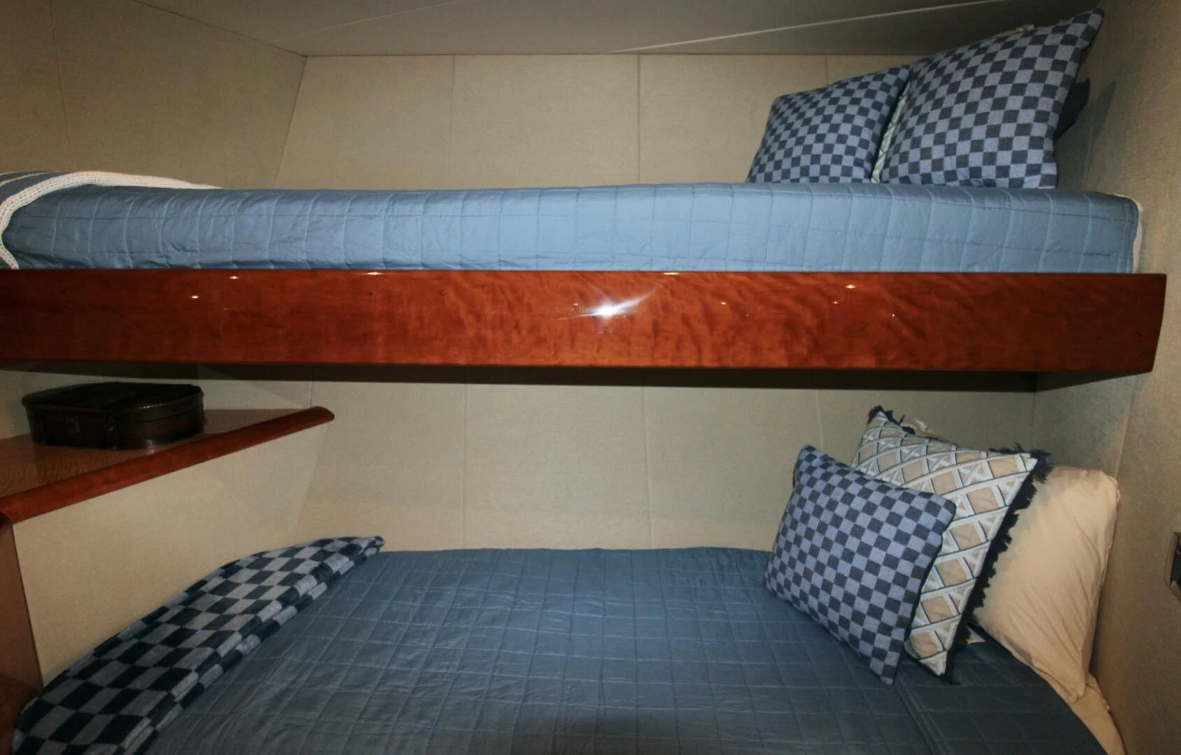 a bed with blue and white sheets aboard KATHLEEN Yacht for Sale
