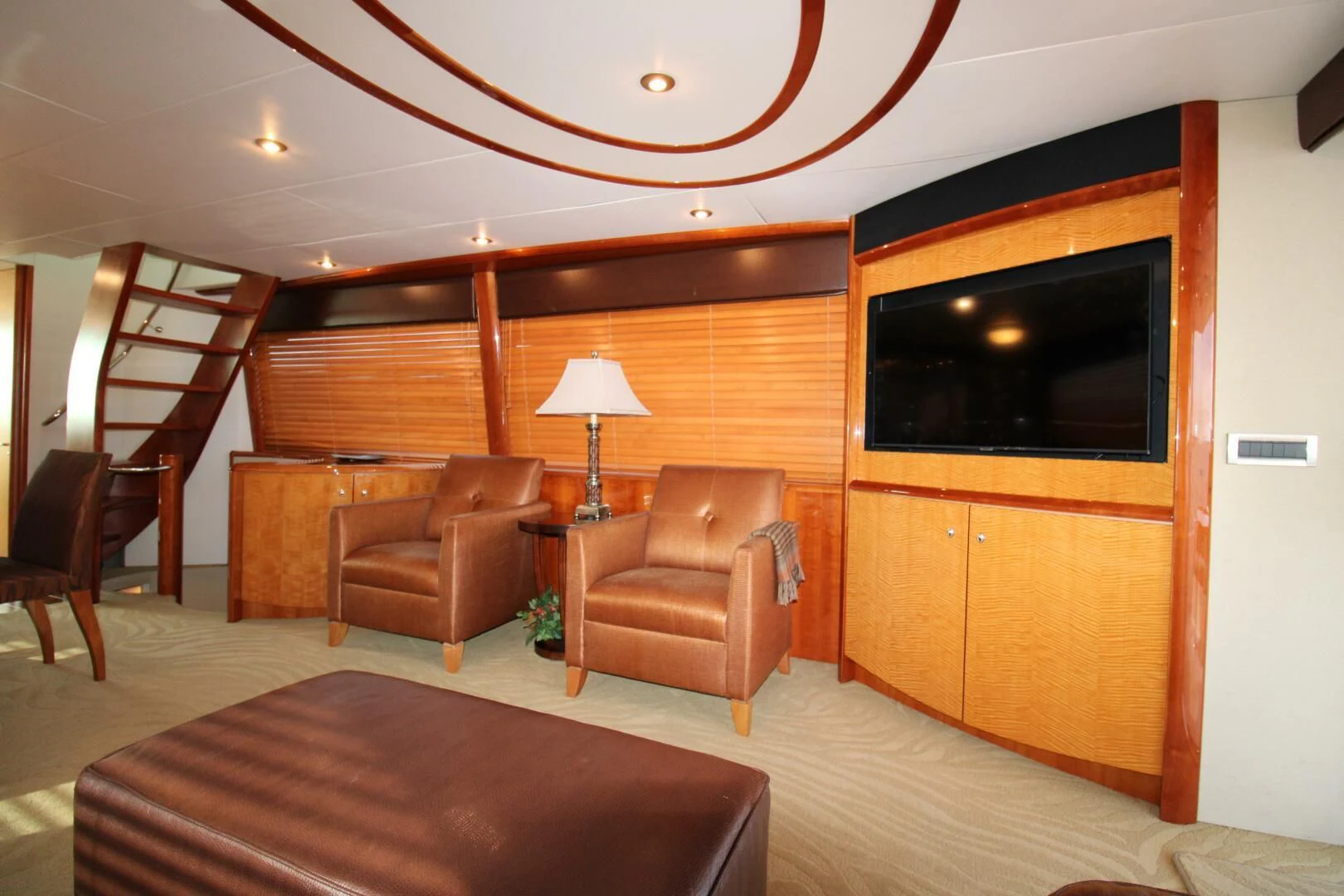 a living room with a tv and furniture aboard KATHLEEN Yacht for Sale