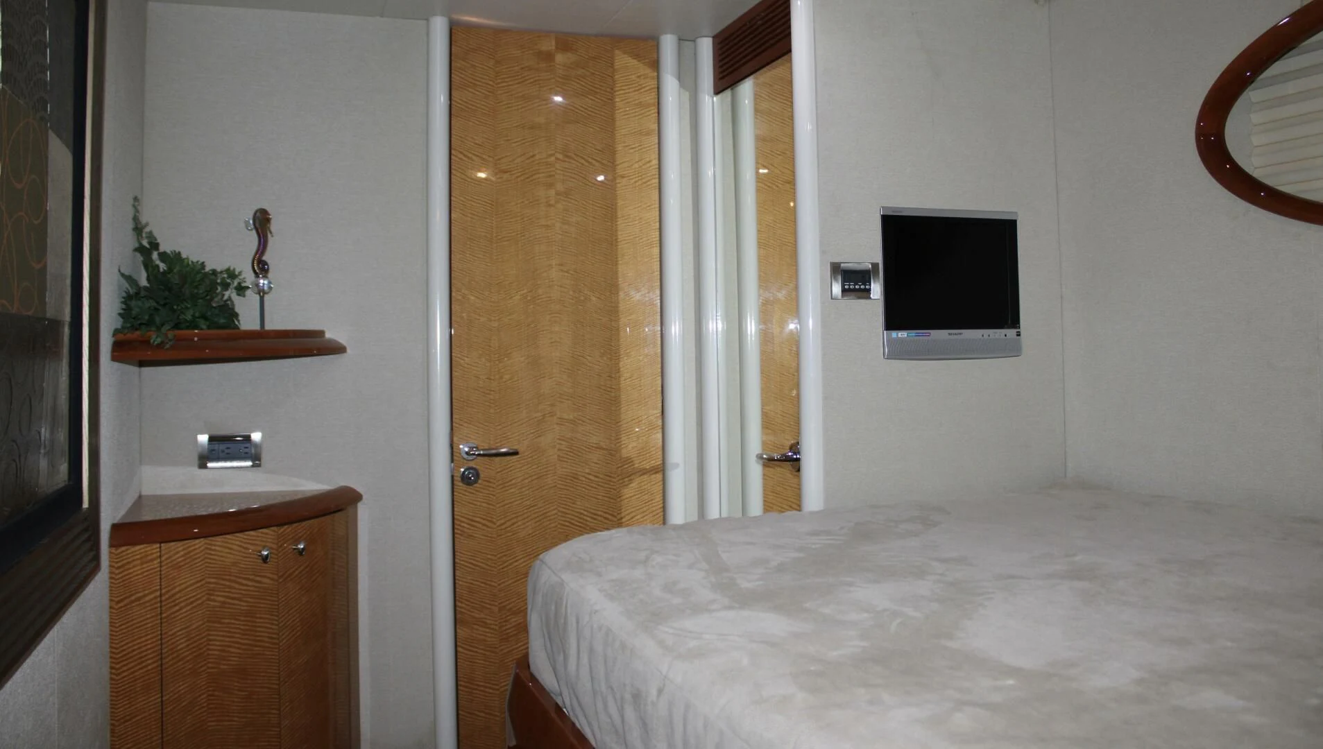 a bedroom with a bed and a television on the wall aboard KATHLEEN Yacht for Sale