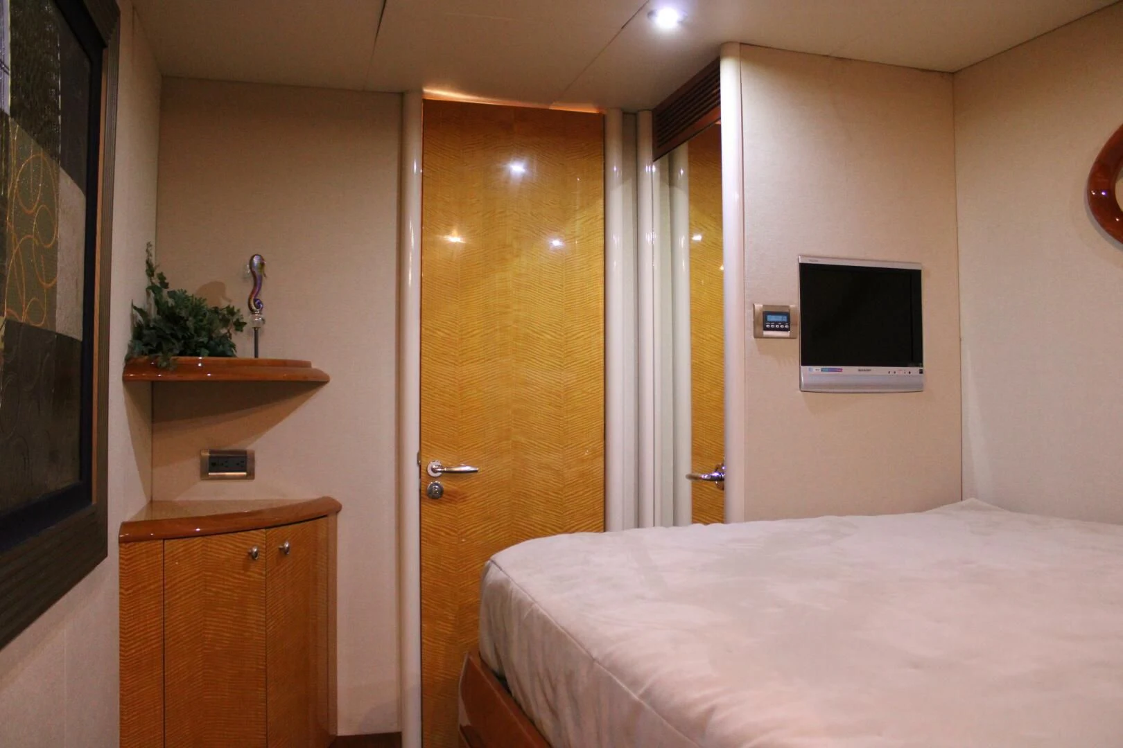 a bedroom with a bed and a television aboard KATHLEEN Yacht for Sale