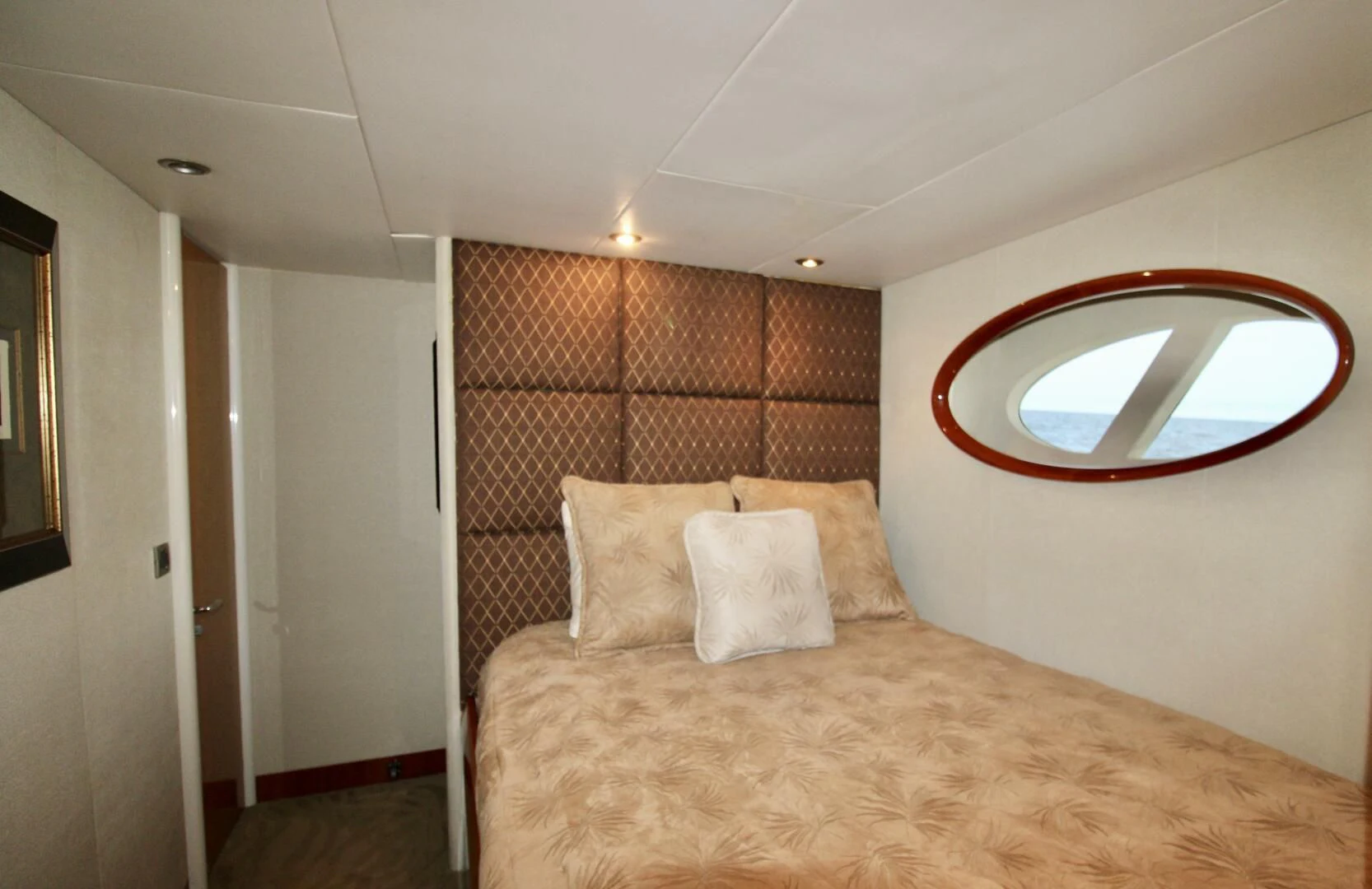 a bed with a mirror above it aboard KATHLEEN Yacht for Sale