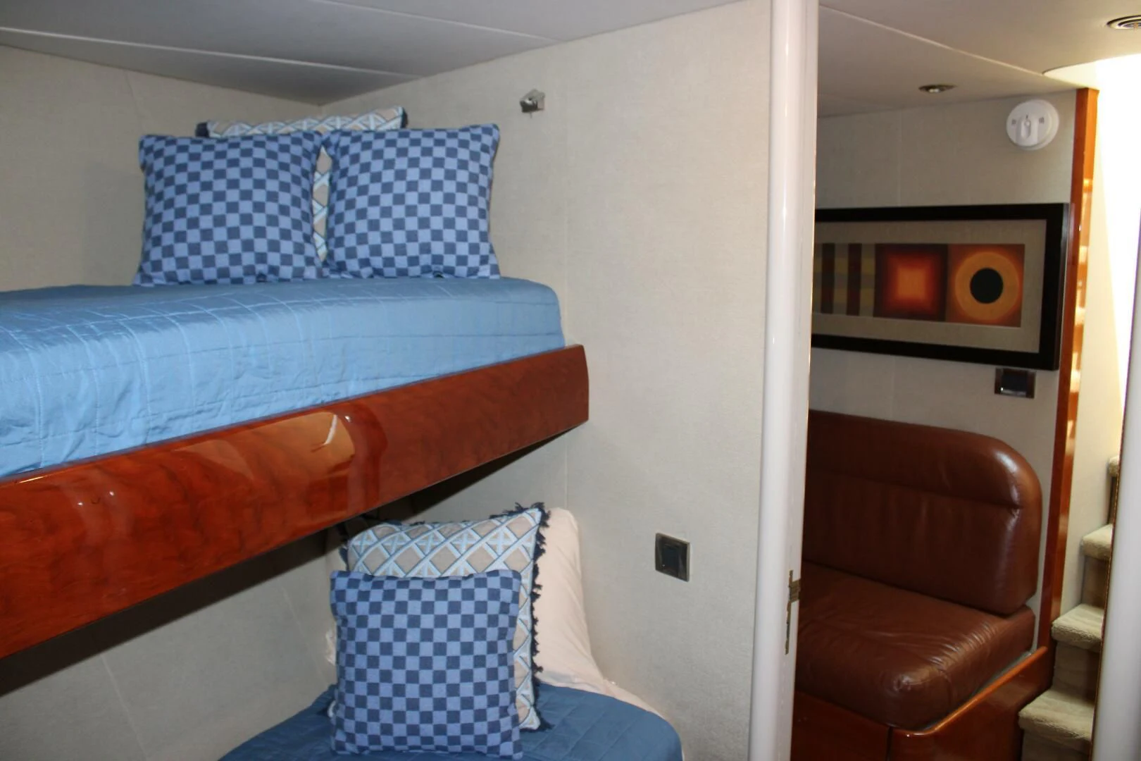 a bed with blue sheets aboard KATHLEEN Yacht for Sale