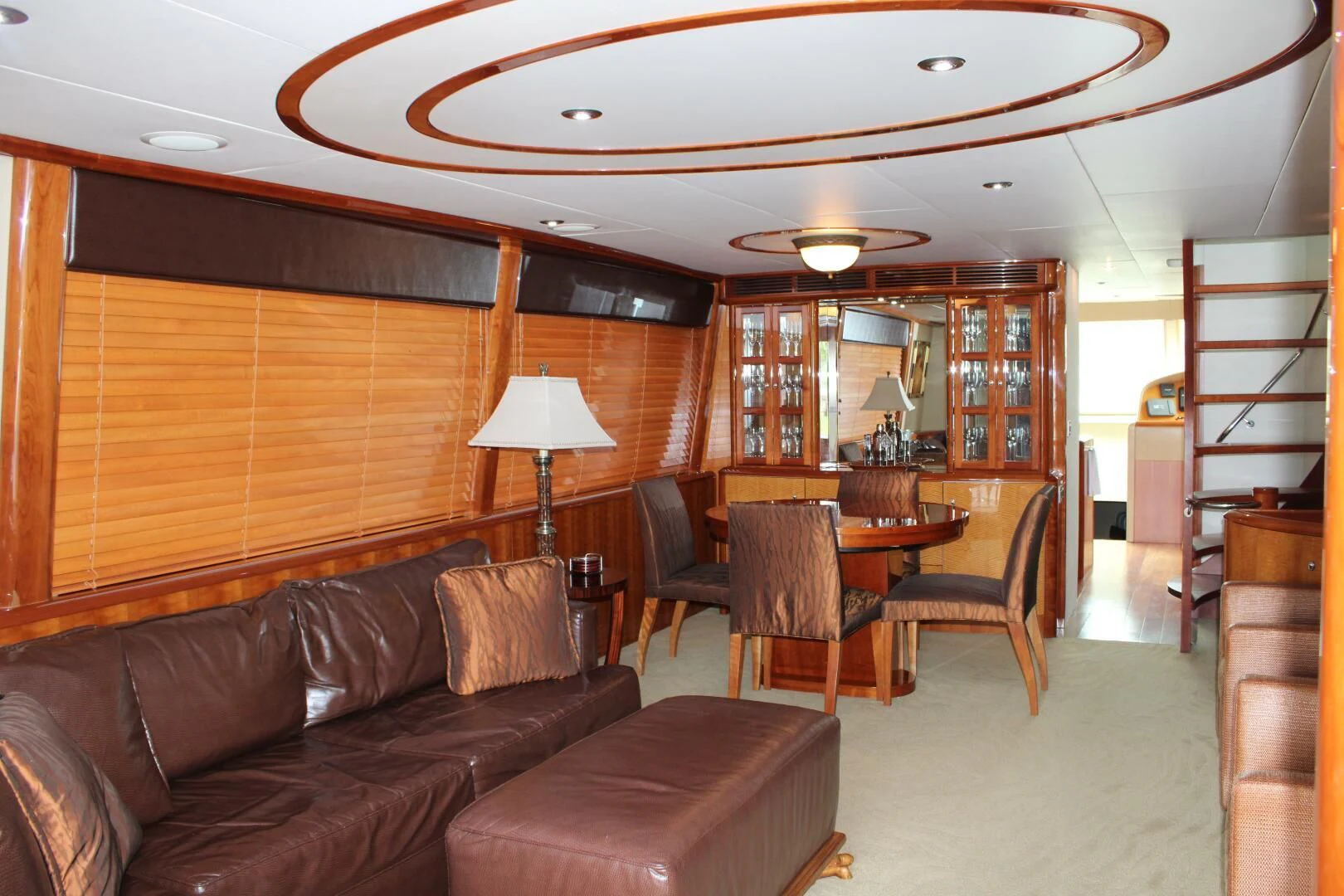 a living room with a leather couch and a wood table aboard KATHLEEN Yacht for Sale