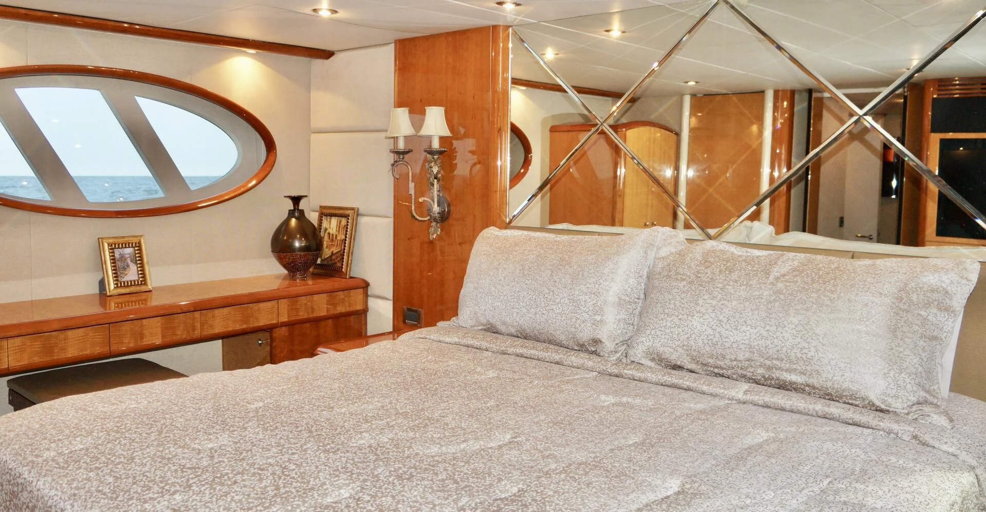 a bed with a large mirror above it aboard KATHLEEN Yacht for Sale