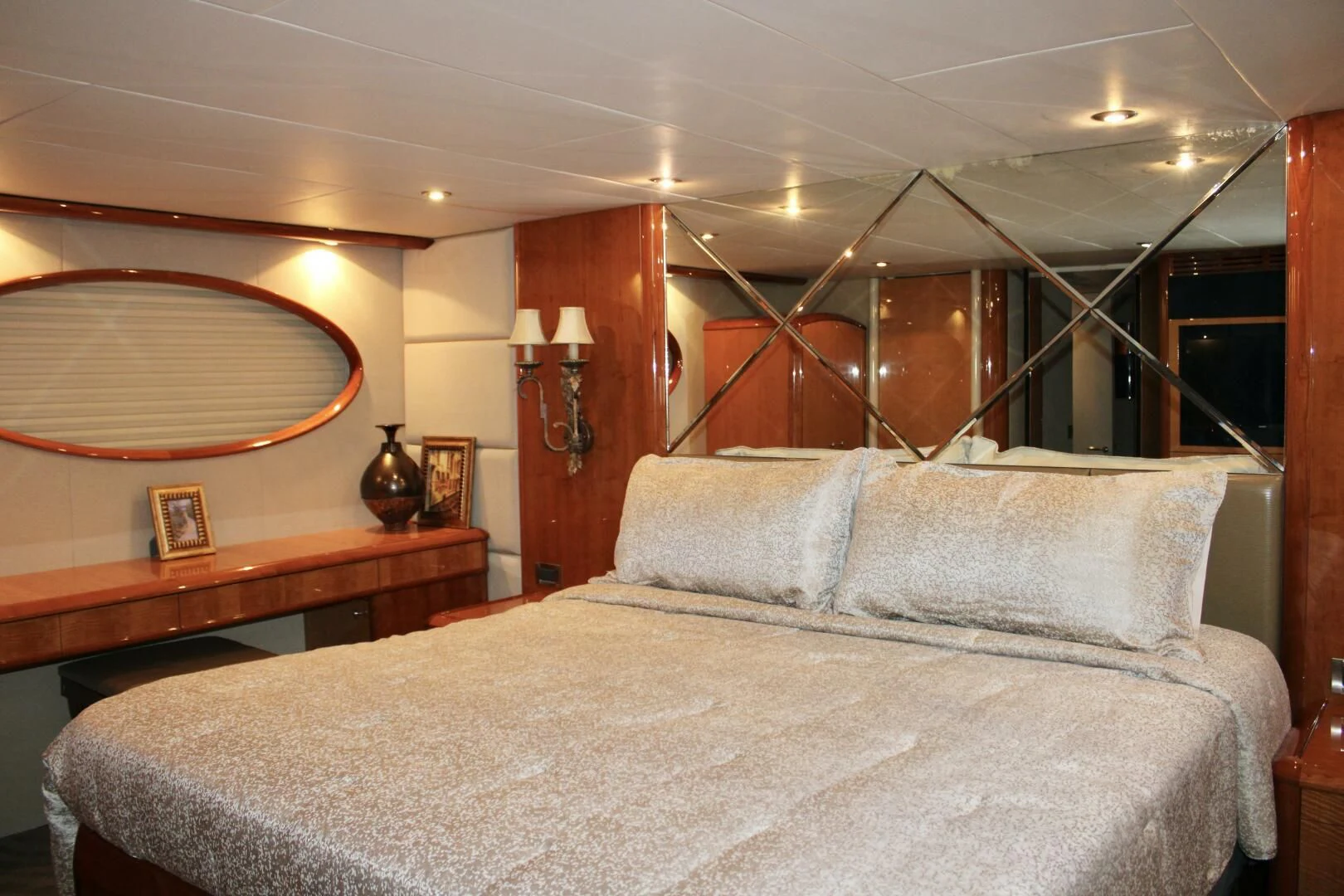 a bed with a large mirror above it aboard KATHLEEN Yacht for Sale