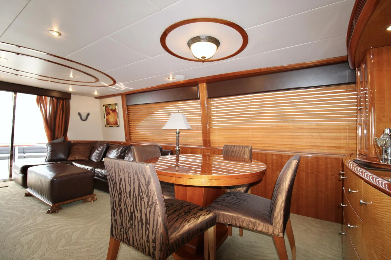 a living room with a leather couch and a wood table aboard KATHLEEN Yacht for Sale