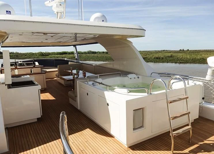 a deck with a large white boat on it and a deck with a view of the water and aboard BISCARI Yacht for Sale