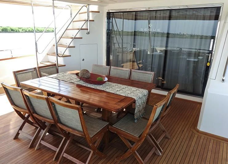 a table and chairs in a room aboard BISCARI Yacht for Sale