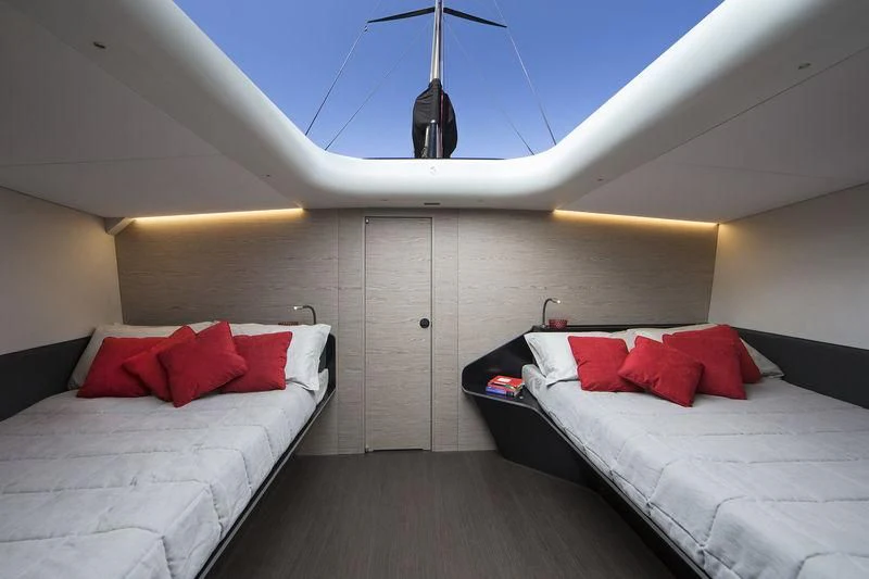 a room with two beds aboard V Yacht for Sale