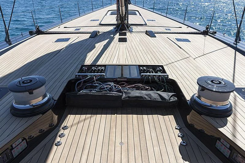 a deck with a deck and a large ship in the water aboard V Yacht for Sale