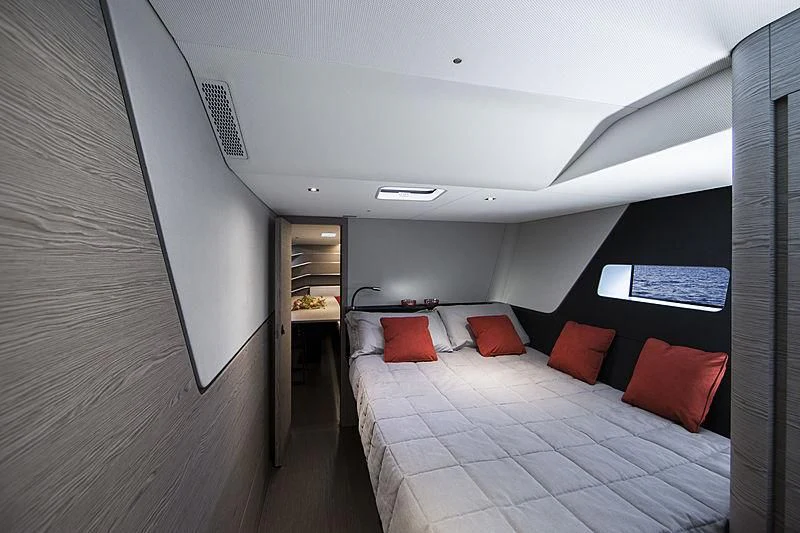 a room with a bed and a table aboard V Yacht for Sale