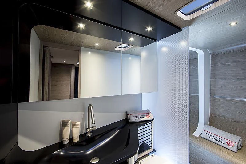 a bathroom with a sink and a mirror aboard V Yacht for Sale