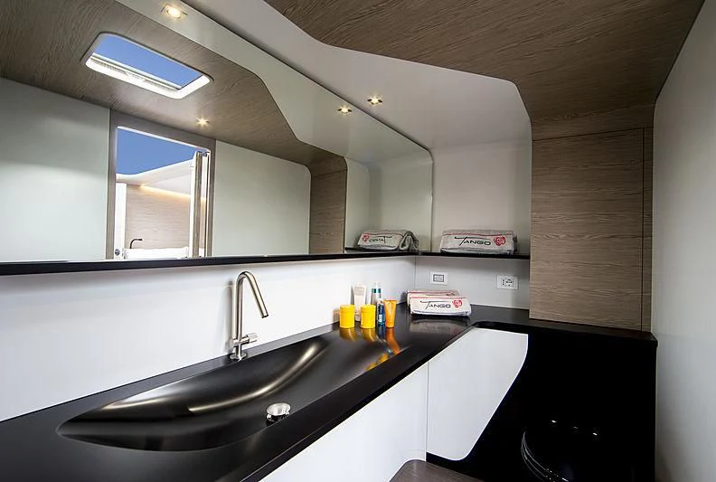 a kitchen with a sink and a large mirror aboard V Yacht for Sale